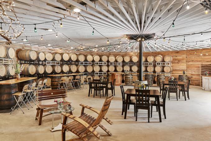 Oak barrels and tasting tables inside the Fabbioli Cellars cellar