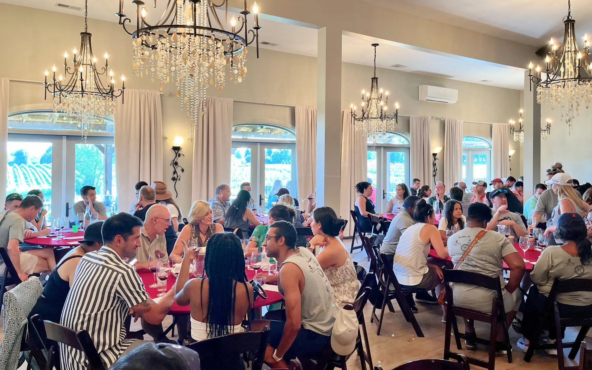 Groups gathered for a tasting in a chandelier-lit room