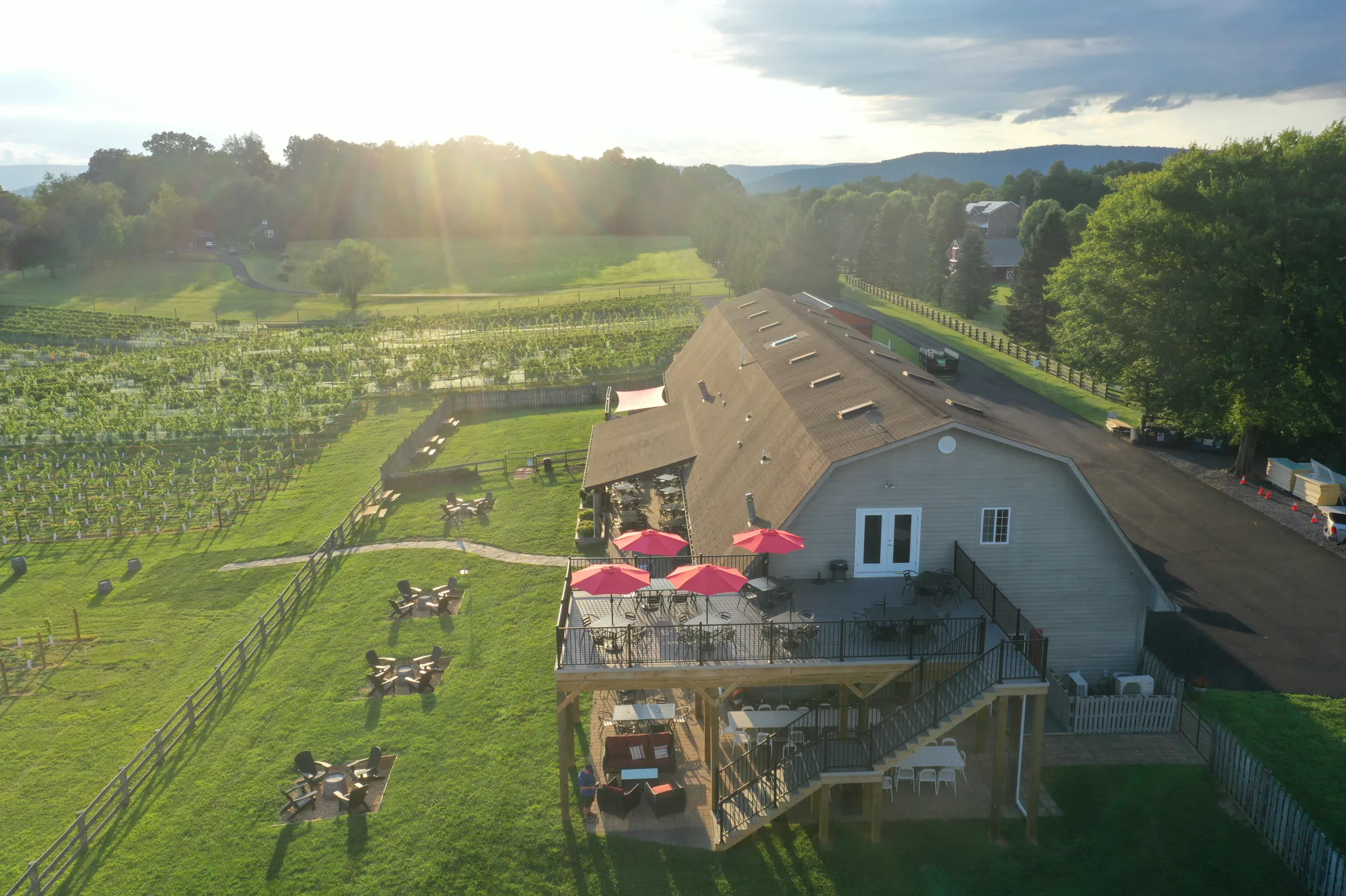 Aerial view of the winery deck, fire pits and vineyard at sunset